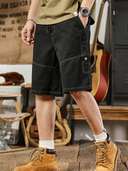Men's black drawstring shorts with relaxed fit and contrast stitching.