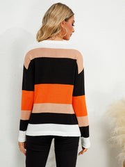 Colorblock crewneck knit sweater with orange, black, tan, and white stripes.