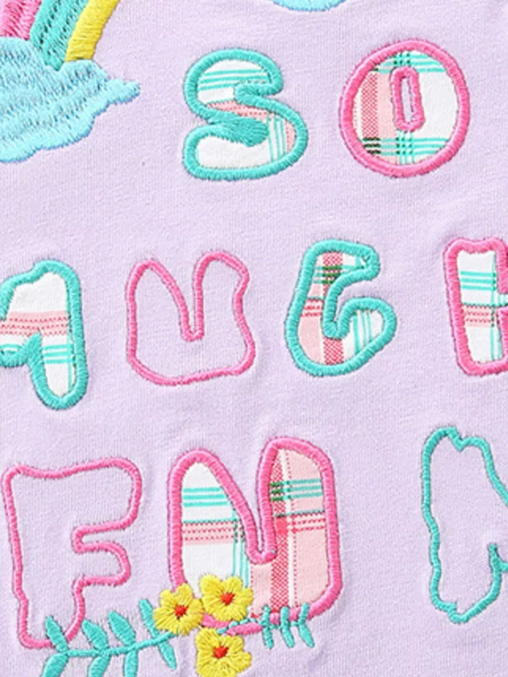 Girls' cotton tee with embroidered letters and rainbow cloud detail.