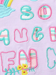 Girls' cotton tee with embroidered letters and rainbow cloud detail.