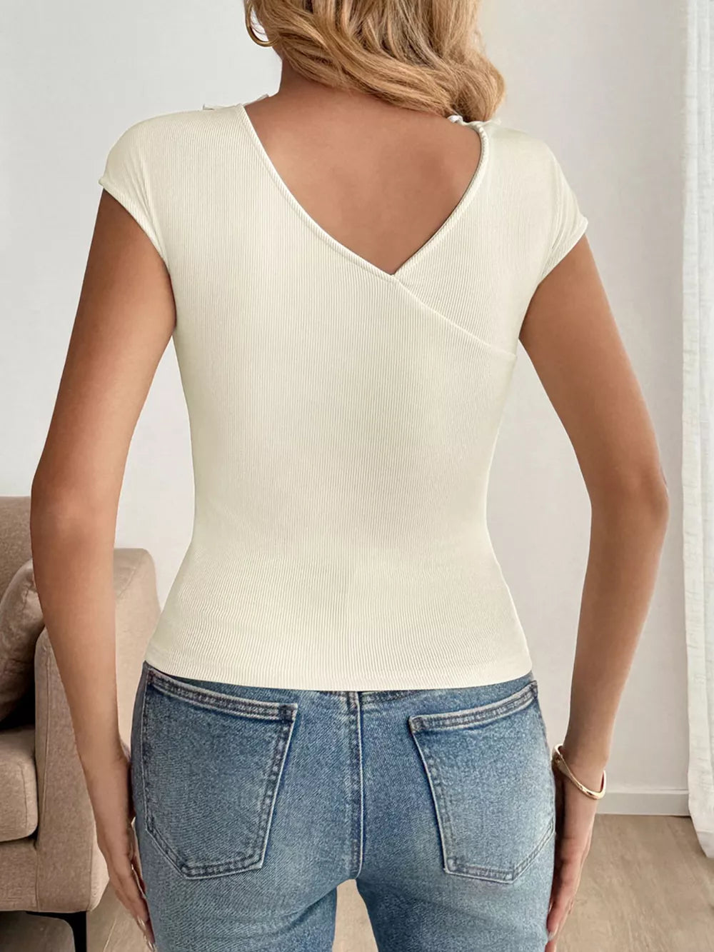 Ribbed knit v-neck t-shirt in cream with short sleeves and a wrap detail.