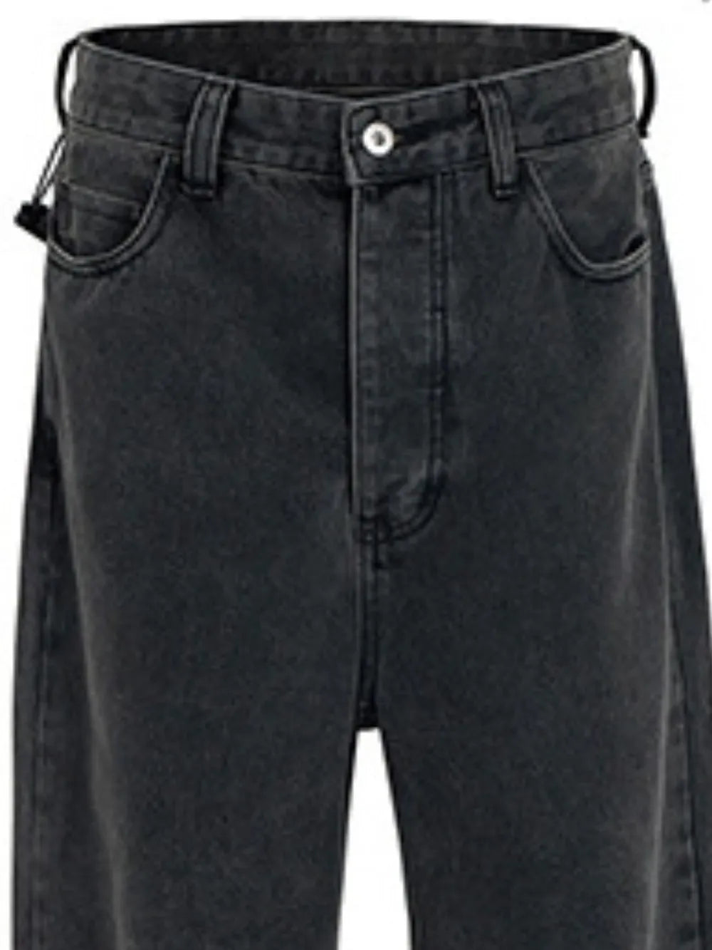 Baggy dark wash denim jeans with a sculpted hemline detail.