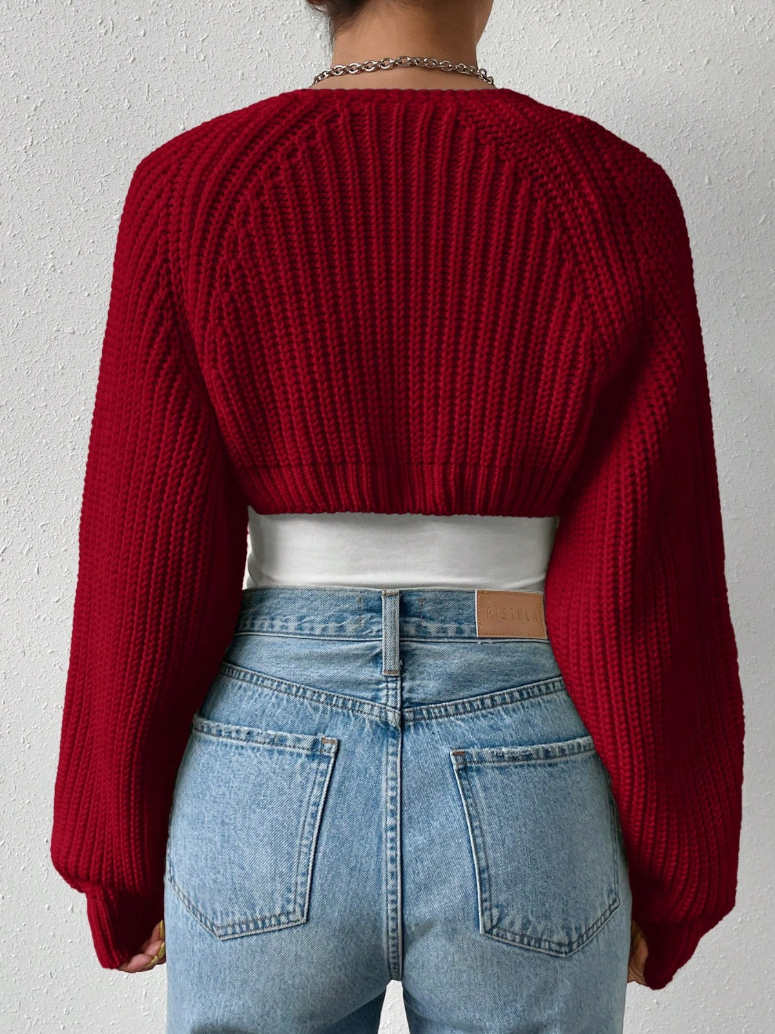 Burgundy cropped bolero shrug with ribbed knit and balloon sleeves, worn over a white top.
