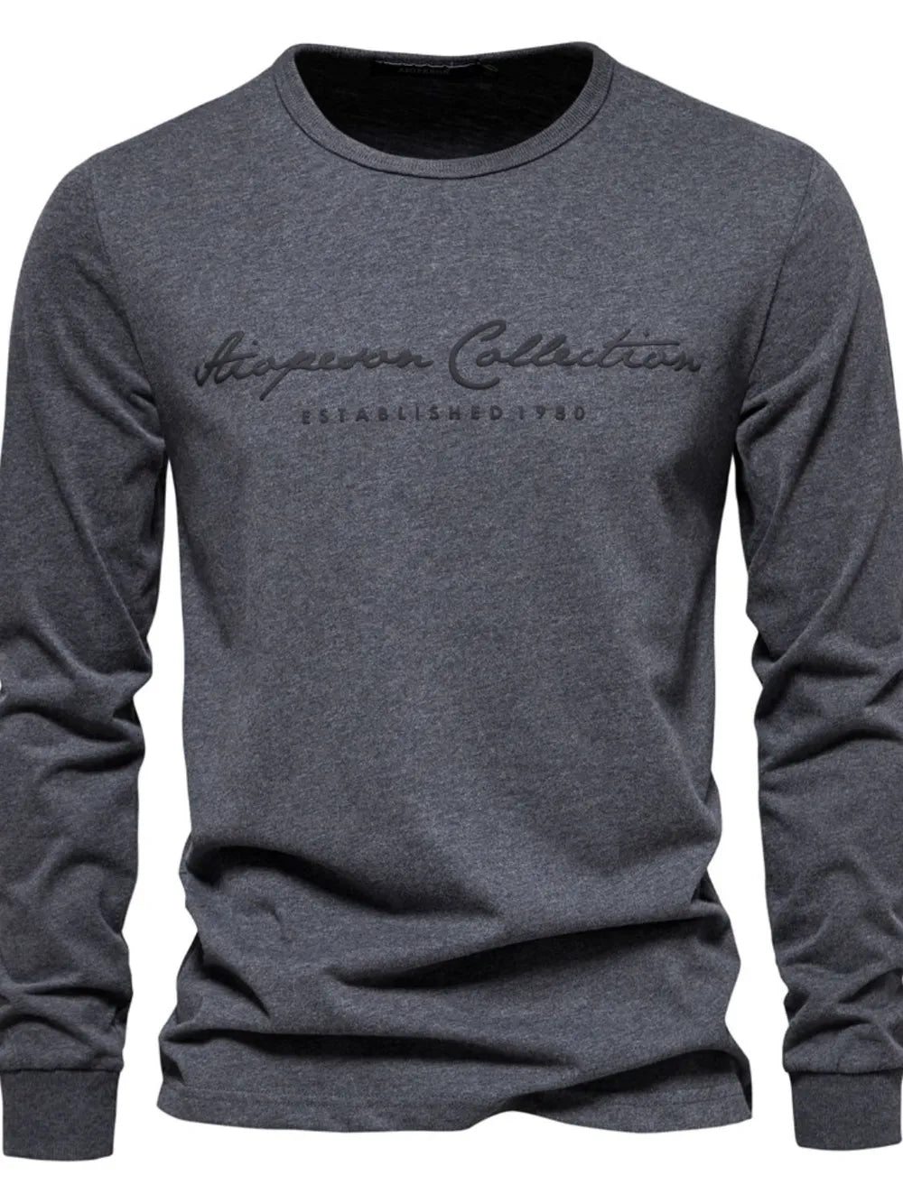 Dark gray crewneck long sleeve t-shirt with embroidered "Aspen Collection Established 1980" graphic.
