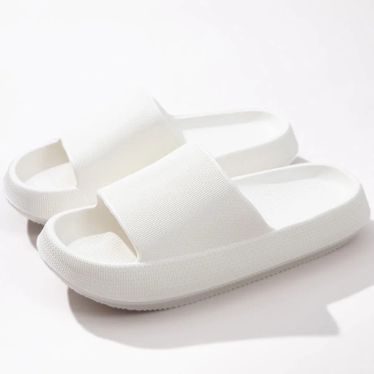 Textured white cloud slides slippers with thick soles and open toe.