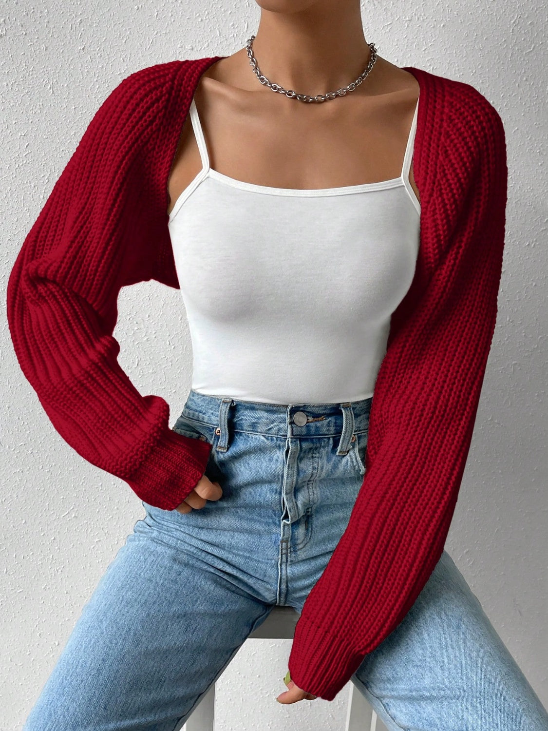 Burgundy cropped bolero sleeve knit shrug with ribbed texture.