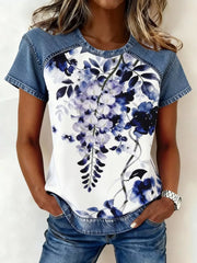 Denim patchwork short sleeve shirt with a white floral print and blue accents.