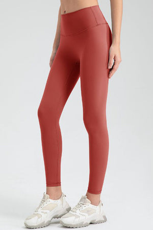 Women's high-waisted leggings in Red Orange, full length, seamless contour detail.
