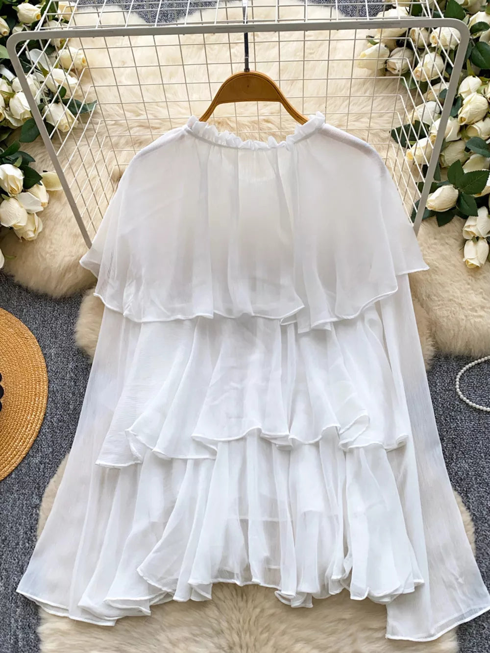 White chiffon blouse with ruffled tiers and a ruffled neckline.