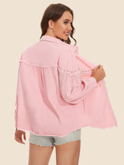 Dusty pink denim trucker jacket with fringe and beaded embellishments on sleeves.