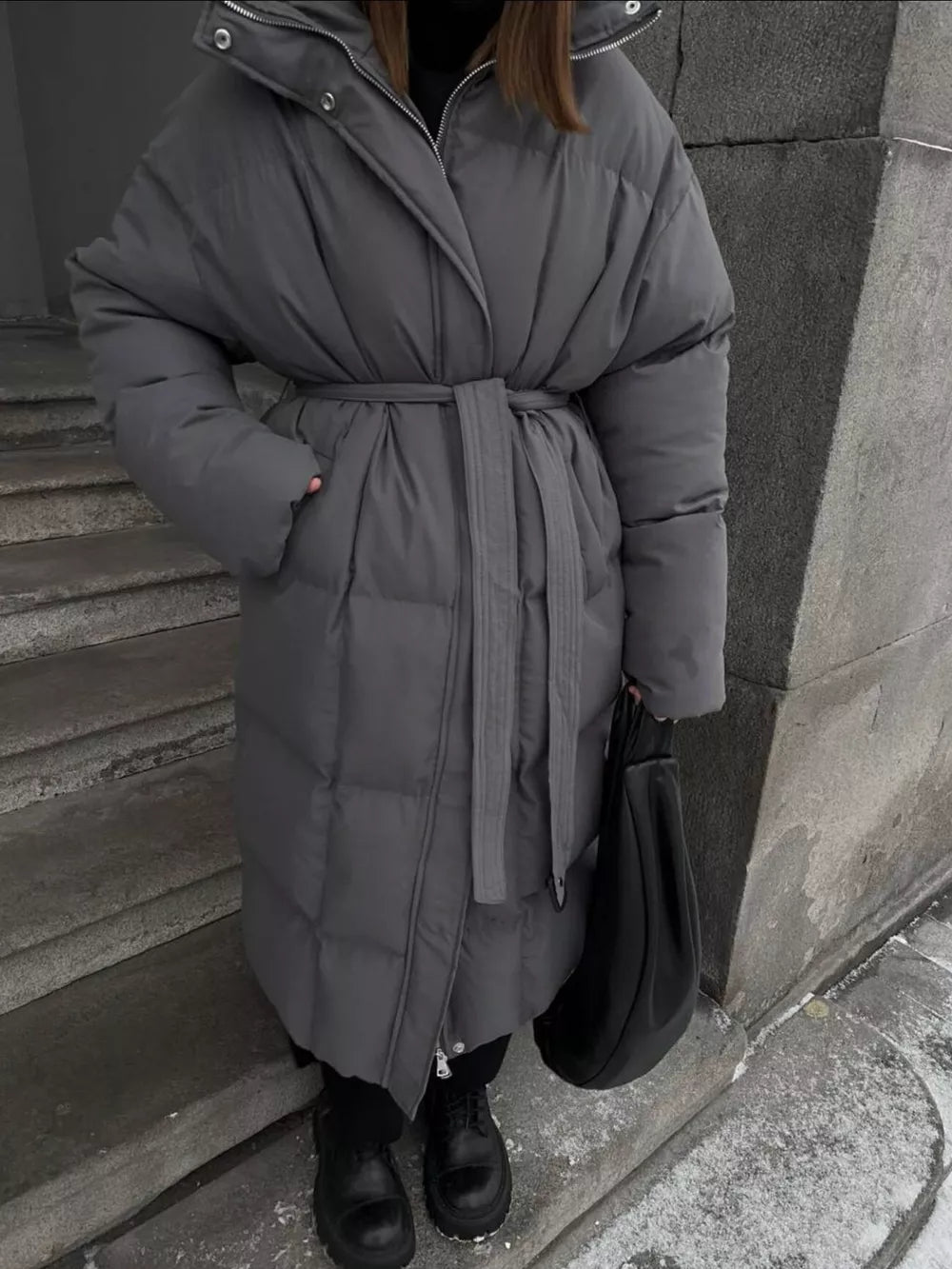 Dark gray padded trench coat with tie-belt and hood, long sleeves, cinched waist