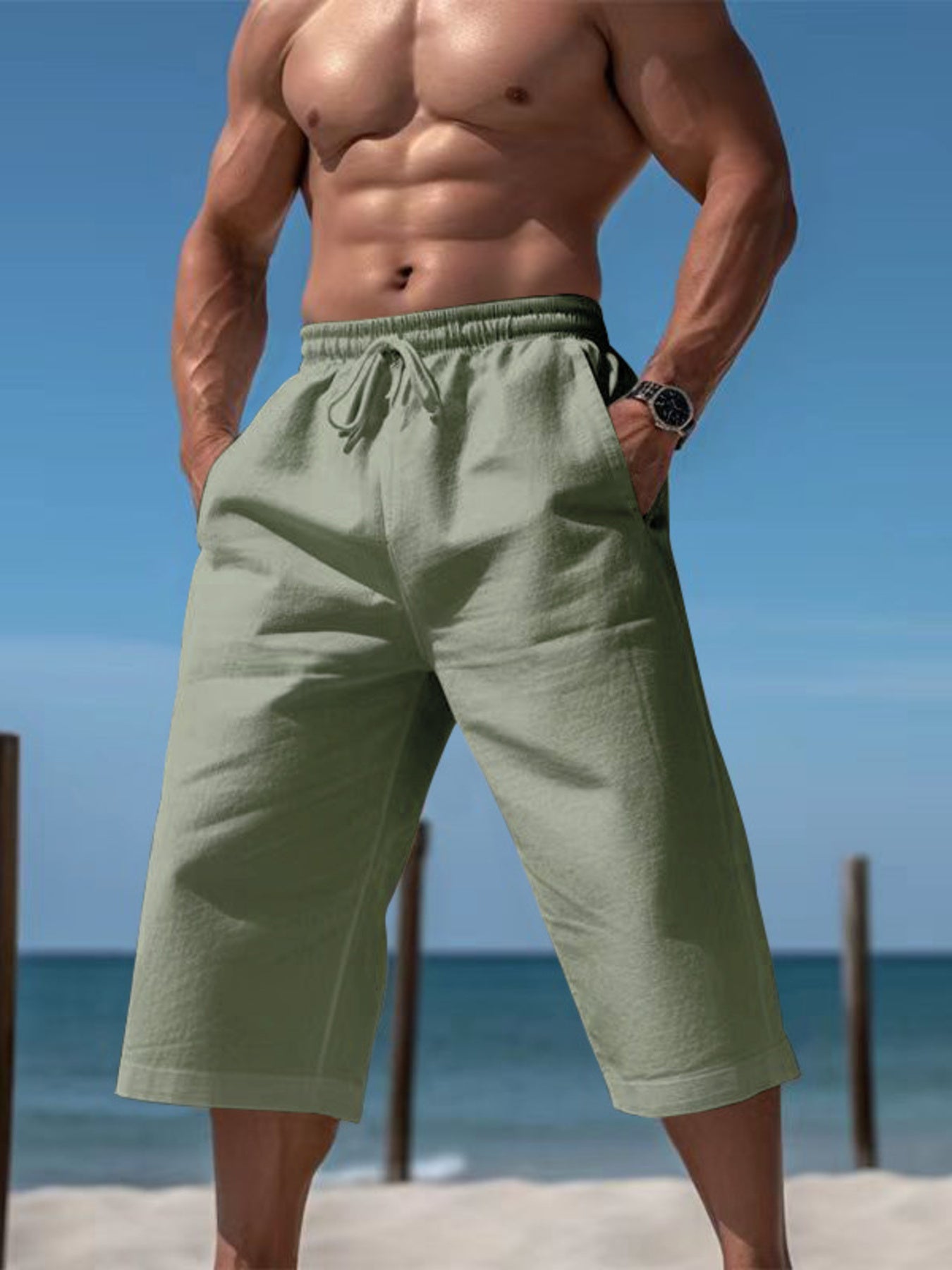 Men's light green relaxed fit drawstring cropped sweatpants with pockets.