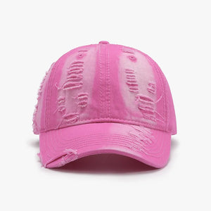 Distressed canvas baseball cap in hot pink with tie-dye effect and frayed details.