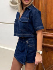 Dark blue denim cropped utility jacket and asymmetric skort set with button detail.