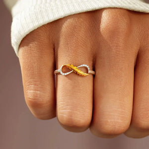 Gold infinity feather ring with clear stones on sterling silver band