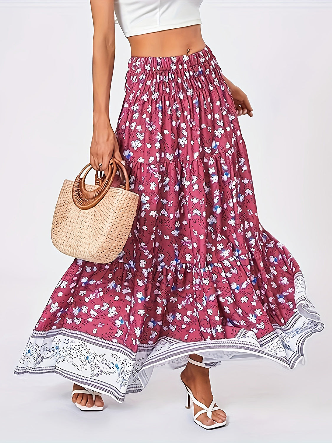 Floral maxi tiered skirt in cerise with a border print, featuring a smocked waist and flowy silhouette.