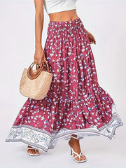 Floral maxi tiered skirt in cerise with a border print, featuring a smocked waist and flowy silhouette.