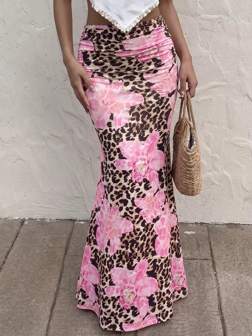Leopard floral bodycon maxi skirt with pink flowers, ruched detail, and a flattering fit.