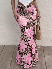 Leopard floral bodycon maxi skirt with pink flowers, ruched detail, and a flattering fit.