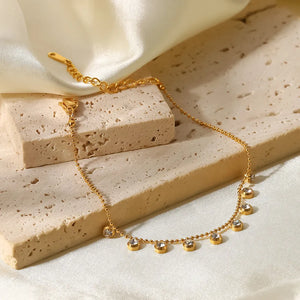 Gold bead bracelet with dangling zirconia charms, 18K gold-plated.