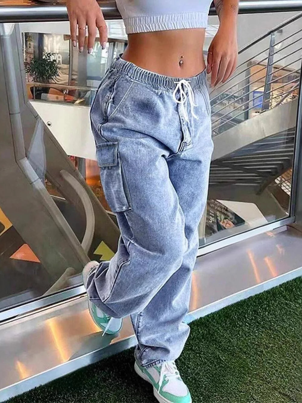 Light wash denim relaxed high-waisted cargo pants with drawstring and pockets