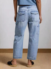 Light wash denim maternity jeans with wide legs, buttoned flap pockets, and utility details.