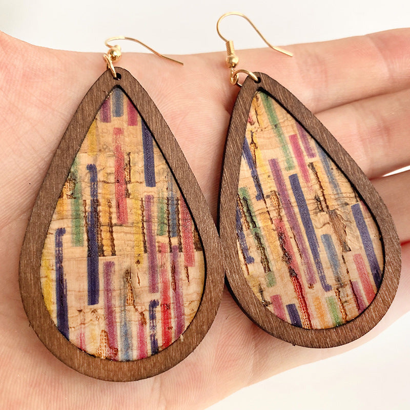 Cork and stripe teardrop statement earrings with wood trim and gold hooks.