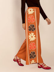 Seventies floral palazzo trousers in tangerine with a bold floral stripe down the leg.