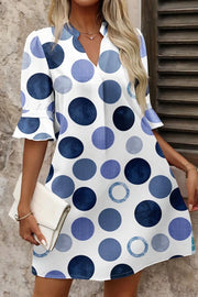 Chic blue polka dot mini dress with flounce sleeves and V-neck.