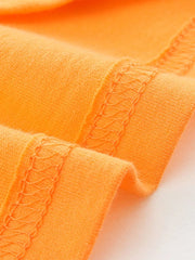 Orange cotton t-shirt detail showing hem stitching