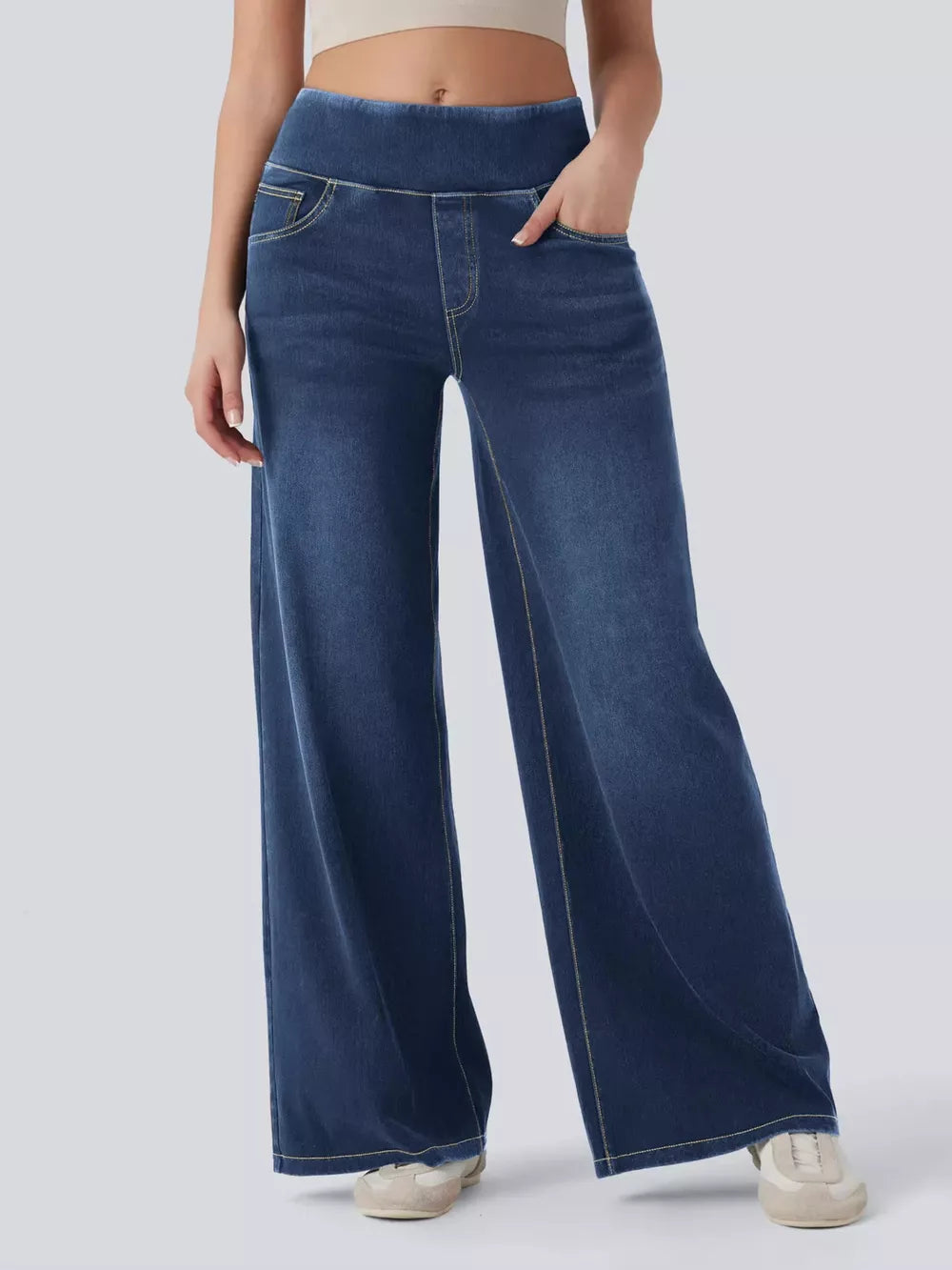 Maternity wide-leg denim jeans in dark blue with yellow stitching and elastic waistband.