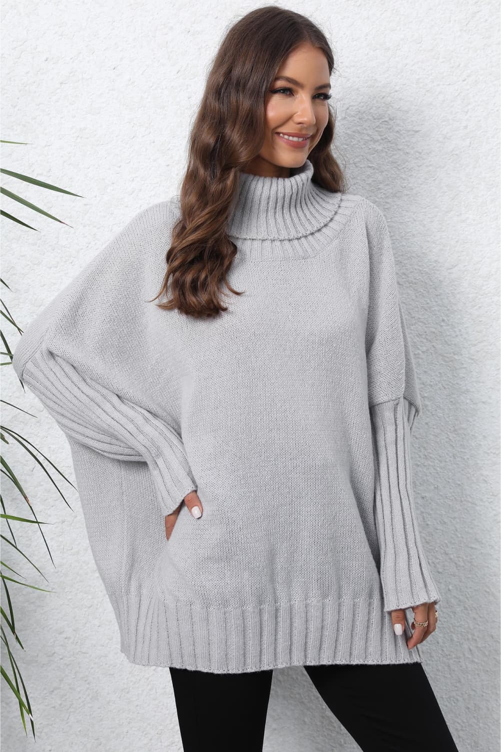 Light Gray ribbed knit turtleneck sweater with batwing sleeves and ribbed cuffs.