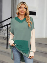 Waffle knit tunic with colorblock design, hood, and pocket.