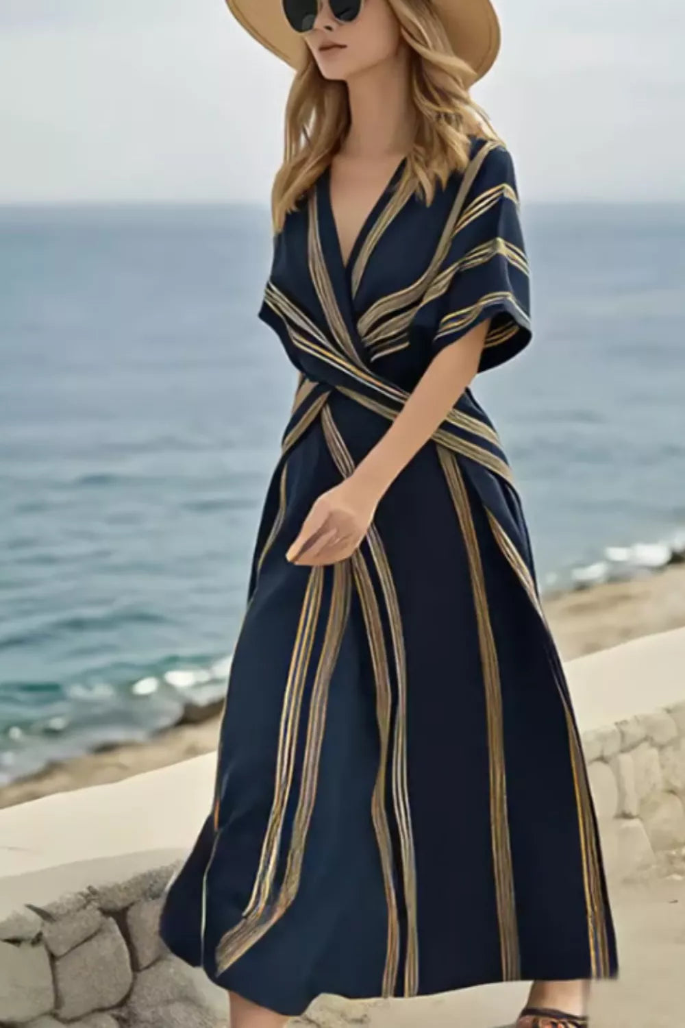 Dark navy wrap maxi dress with gold stripes, V-neck, short sleeves, and flowing skirt.