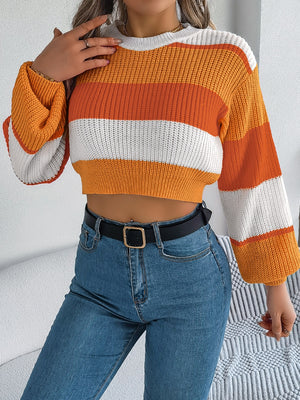 Striped acrylic crop knit sweater with balloon sleeves in tangerine and white.