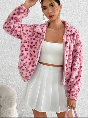 Blush pink faux fur zip track jacket with a heart pattern, featuring a collar and long sleeves.