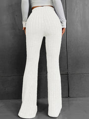 White ribbed flare trousers with a high waist and polyester fabric.