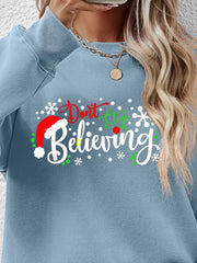 Air Force Blue long sleeve sweater with "Don't Stop Believing" graphic and Santa hat detail.
