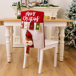Christmas chair cover in deep red with white Merry Christmas text and a snowman applique.