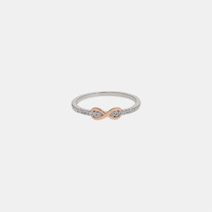 Infinity knot ring with rose gold and diamond accents.