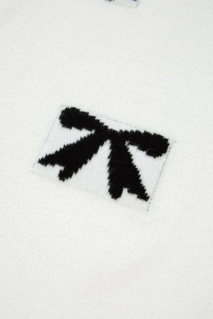 White knit tunic with black bow motif detail