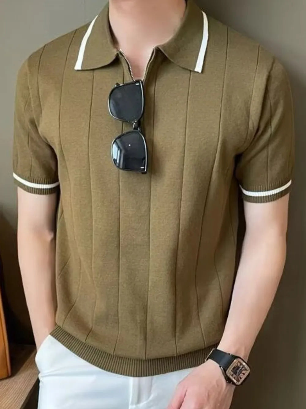 Olive ribbed knit polo with contrast trim and zipper neckline.