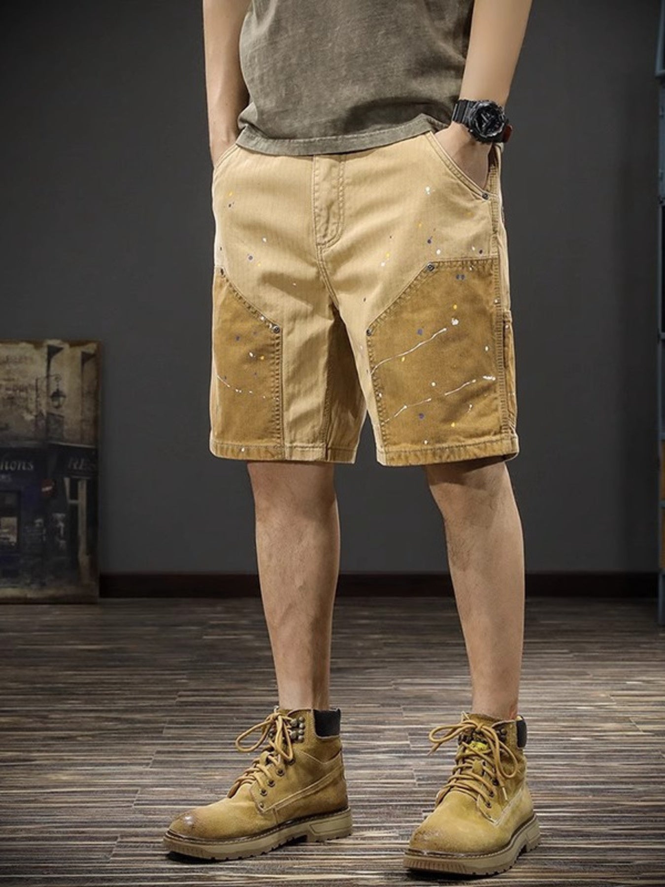 Men's tan cargo shorts with paint splatter detail and contrasting panels.