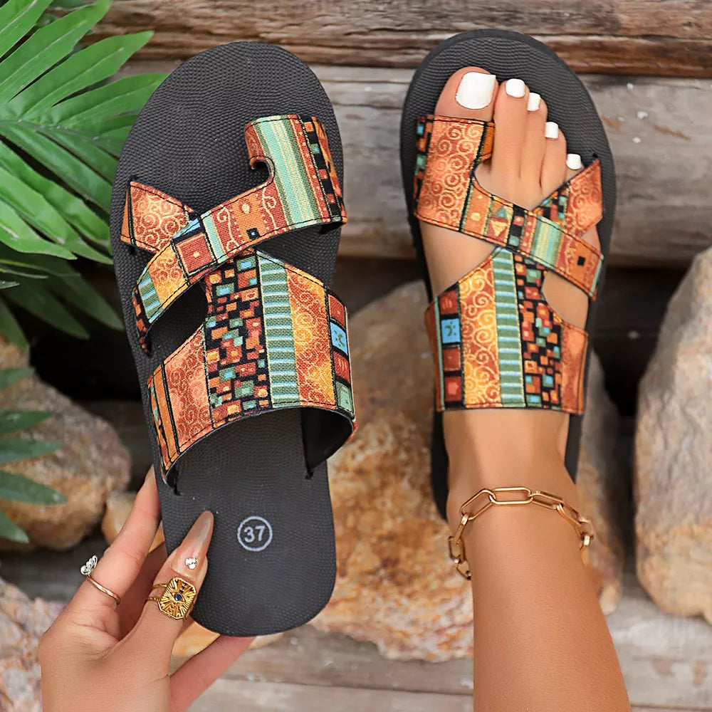 Geometric patterned toe loop sandals with colorful straps and a comfortable fit.