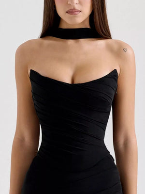 Black sweetheart tube top dress with ruched detailing and a choker neckline.