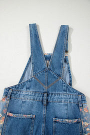Denim overalls with vintage floral print trim on pockets and sides.