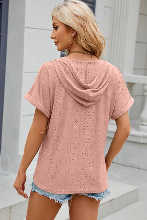 Blush pink perforated hooded tee with short sleeves and a relaxed fit.