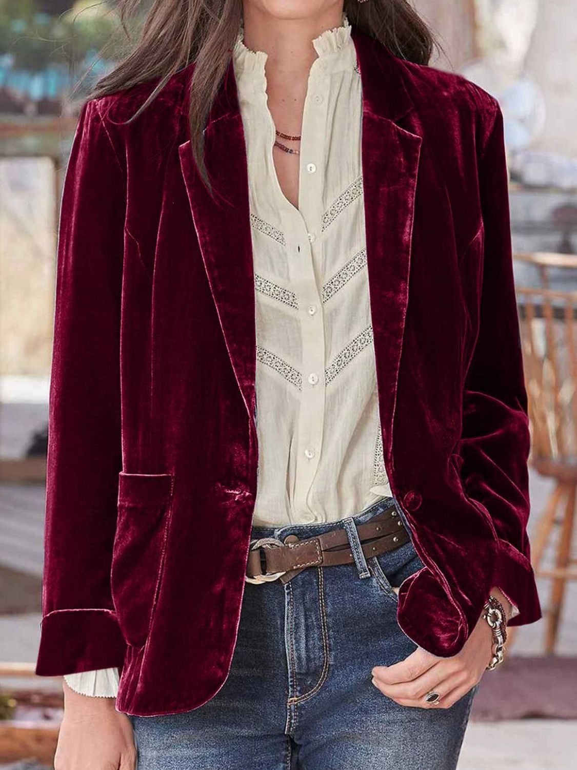 Burgundy velvet blazer with rolled cuff detail and button closure, styled with a white lace-trimmed blouse.