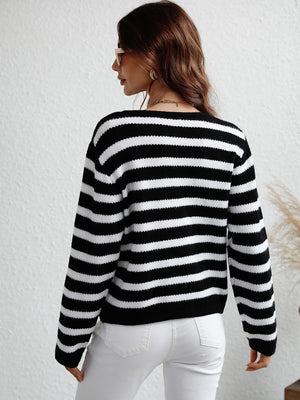 Black and white horizontal stripe knit cardigan with crew neck and long sleeves.