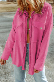 Hot pink textured shacket with raw-edge detailing and buttoned pockets.